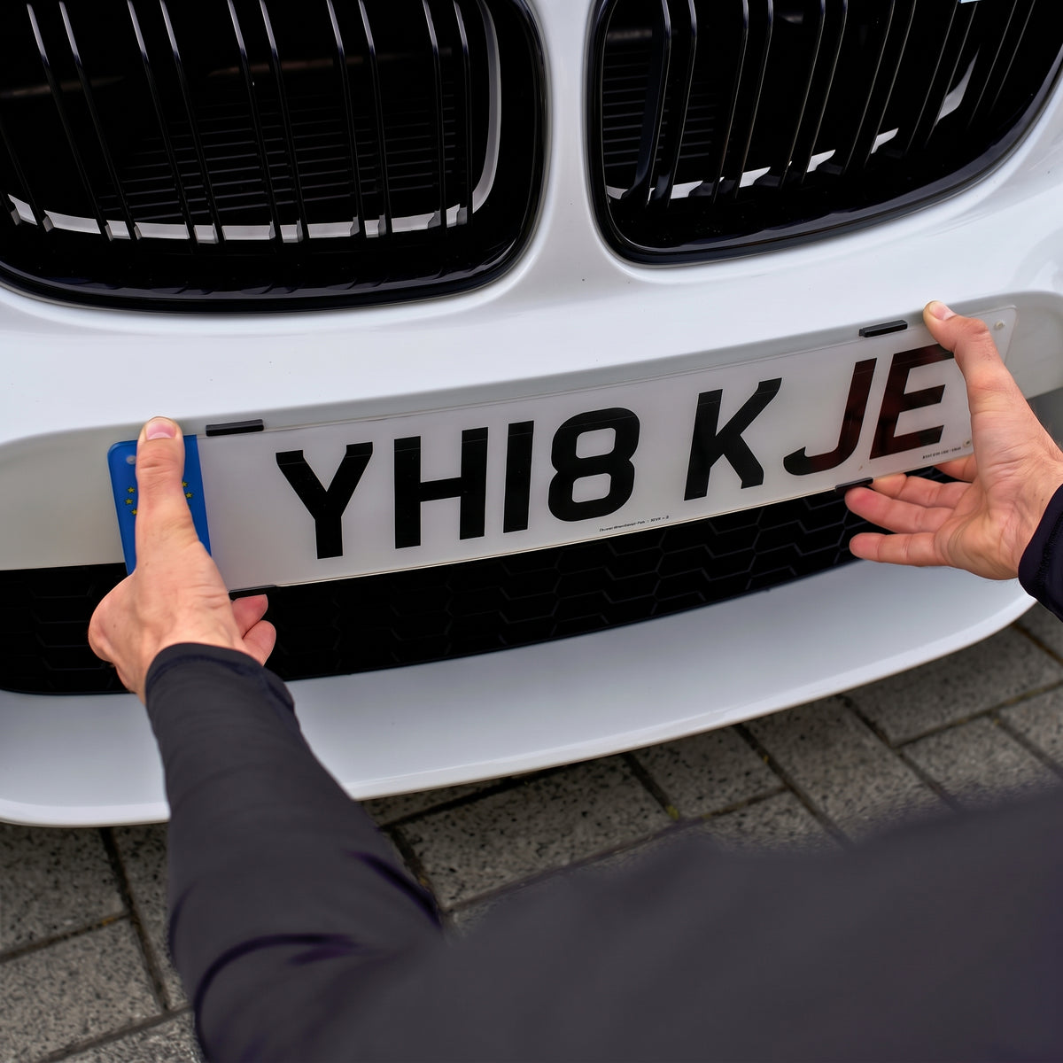Fitting a UK front number plate into the black PLEXICLICK® V1.3D UK clips